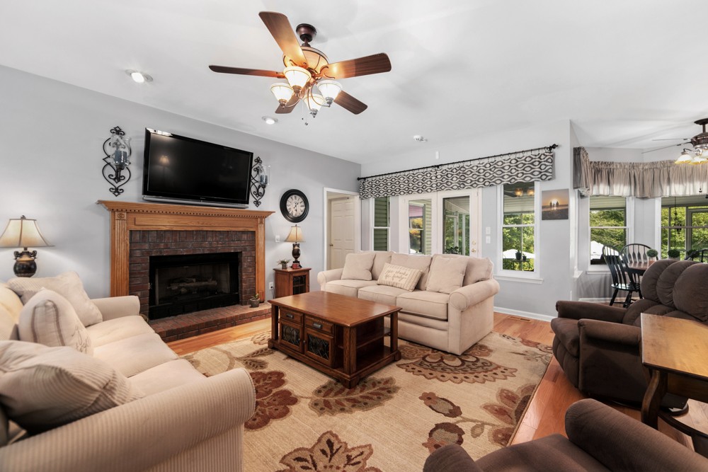 105 Spicer Road Burns, TN 37029 - Photo 10 of 44 a living room with furniture a flat screen tv and a fireplace