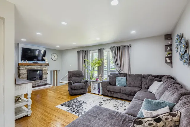 a living room with furniture and a fireplace