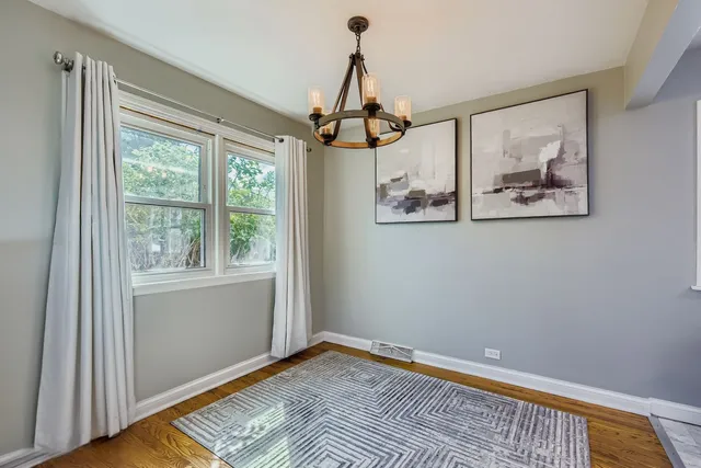 a view of room with window and wooden floor