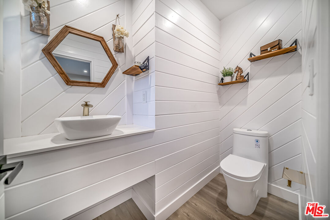 5619 Bellingham Avenue Valley Village, CA 91607 - Photo 15 of 48 a bathroom with a toilet sink and mirror