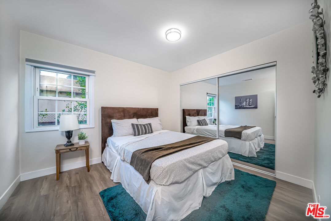 5619 Bellingham Avenue Valley Village, CA 91607 - Photo 20 of 48 a bed room with bed and a night stand