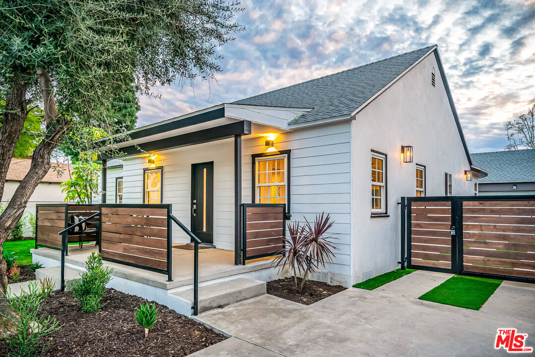 5619 Bellingham Avenue Valley Village, CA 91607 - Photo 2 of 48 a view of a house with wooden fence next to a road