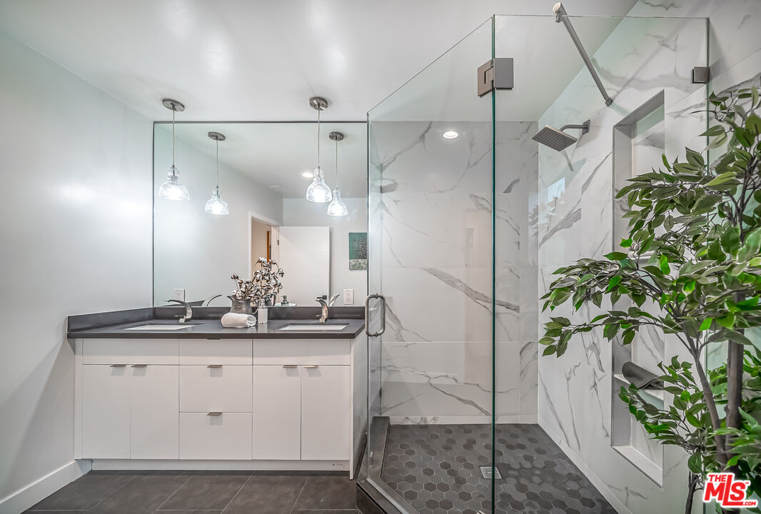 5619 Bellingham Avenue Valley Village, CA 91607 - Photo 26 of 48 a bathroom with a sink a mirror and vanity