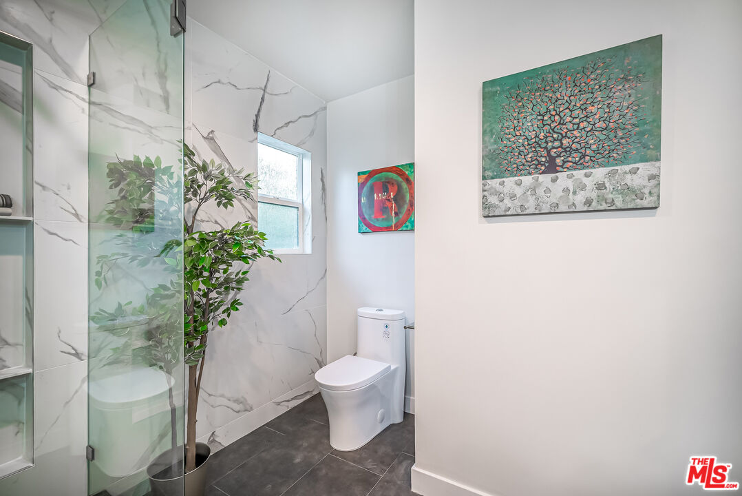 5619 Bellingham Avenue Valley Village, CA 91607 - Photo 27 of 48 a bathroom with a toilet and a shower