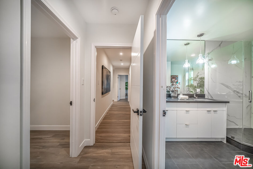 5619 Bellingham Avenue Valley Village, CA 91607 - Photo 28 of 48 a view of a hallway with wooden floor and staircase