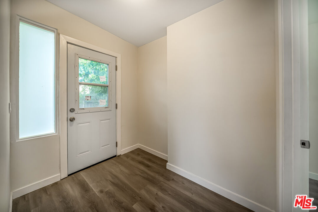 5619 Bellingham Avenue Valley Village, CA 91607 - Photo 34 of 48 a view of an empty room with wooden floor and a window