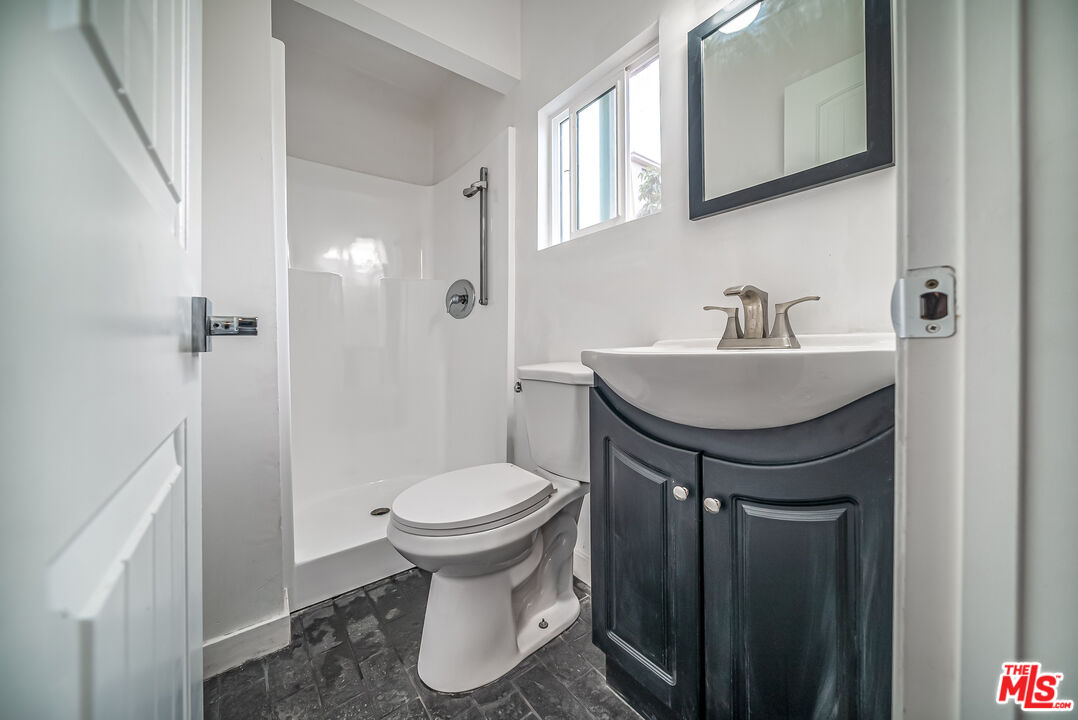 5619 Bellingham Avenue Valley Village, CA 91607 - Photo 37 of 48 a bathroom with a sink toilet and a mirror