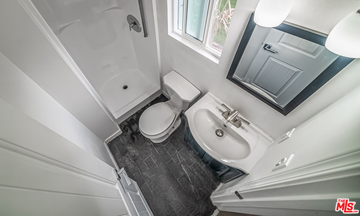5619 Bellingham Avenue Valley Village, CA 91607 - Photo 38 of 48 a bathroom with a granite countertop sink mirror vanity and toilet