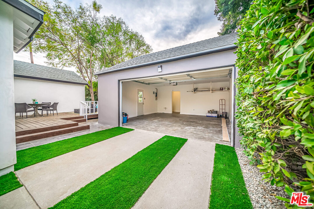 5619 Bellingham Avenue Valley Village, CA 91607 - Photo 40 of 48 a front view of a house with a yard and potted plants