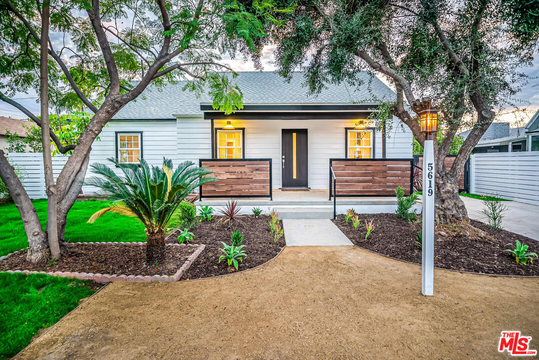 5619 Bellingham Avenue Valley Village, CA 91607 - Photo 4 of 48 a front view of a house with a yard and potted plants