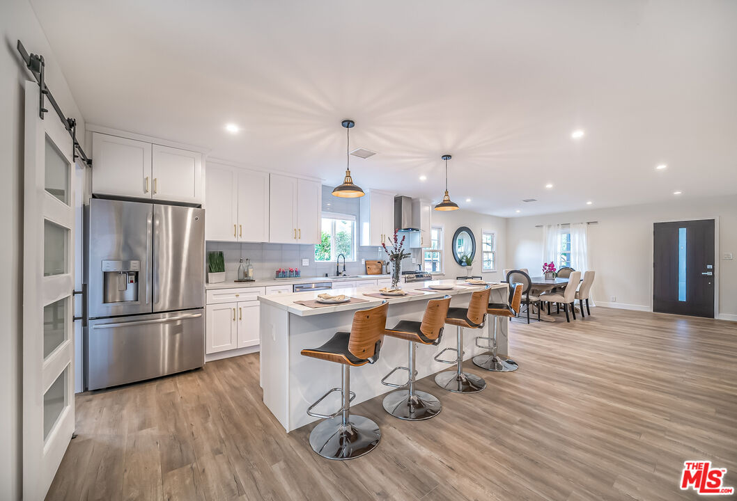 5619 Bellingham Avenue Valley Village, CA 91607 - Photo 8 of 48 a large kitchen with a table and chairs in it