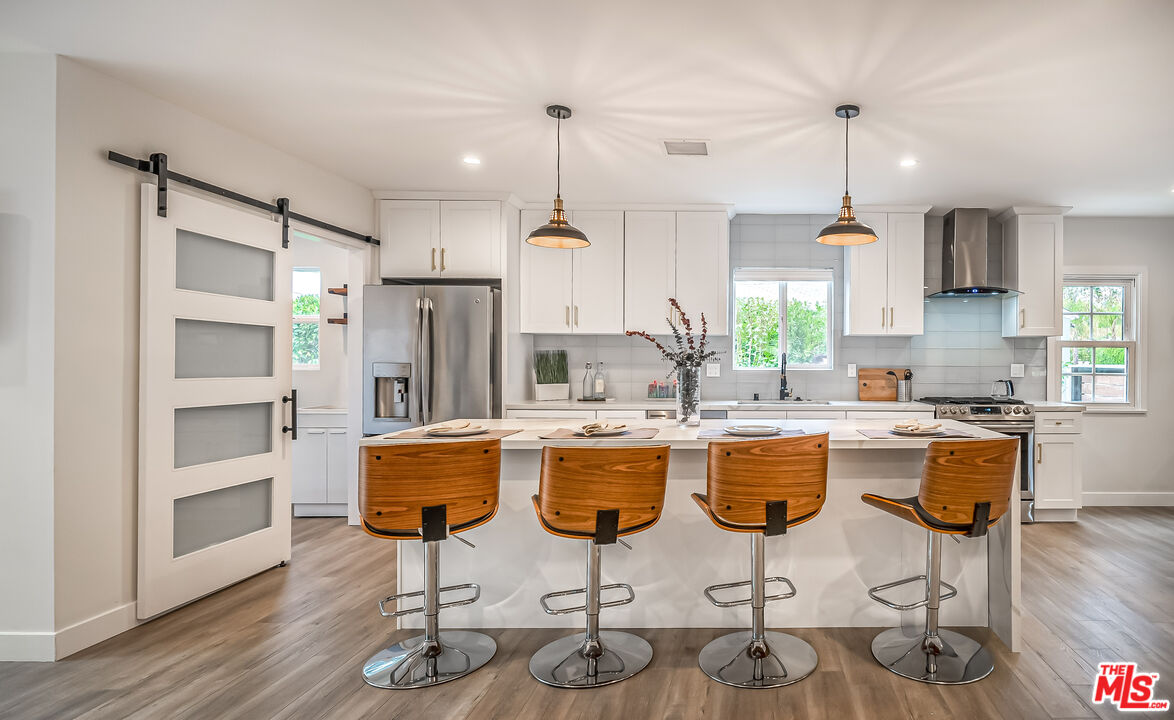 5619 Bellingham Avenue Valley Village, CA 91607 - Photo 10 of 48 a kitchen with appliances cabinets and chair