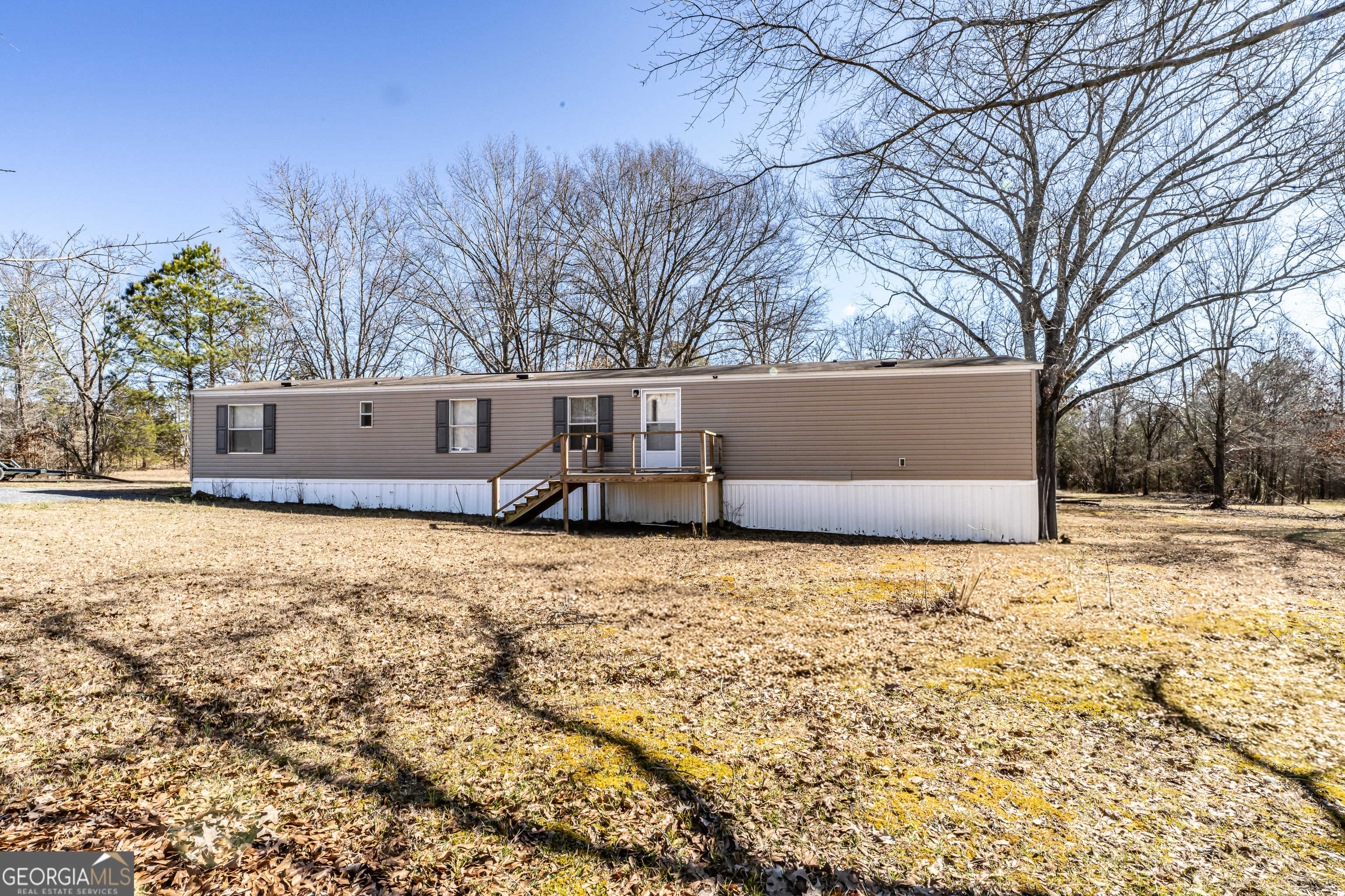 a view of a yard with large trees