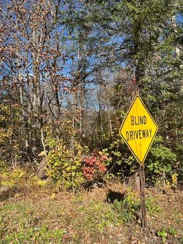 a sign that is sitting on a rock