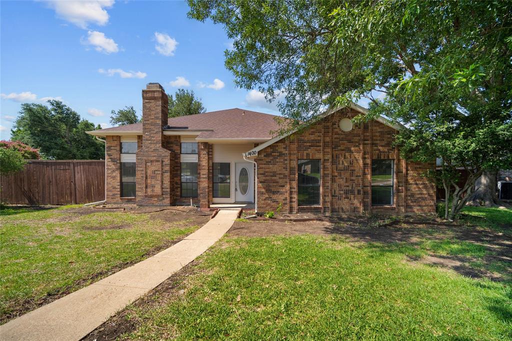 a front view of a house with a garden and patio