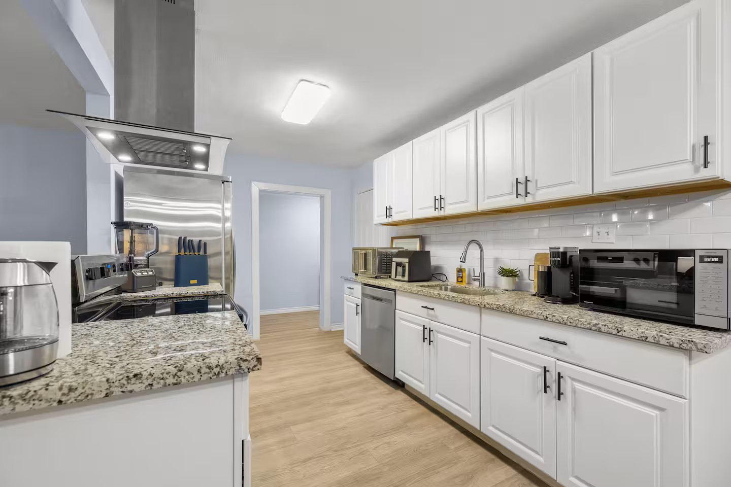 3719 Odin Court Houston, TX 77021 - Photo 11 of 39 Remodeled kitchen with new cabinets, granite countertops, tile backsplash, and stainless steel appliances.