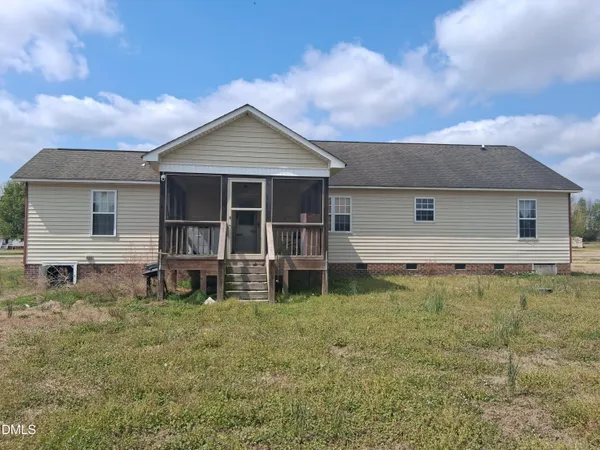 a view of a house with a yard and sitting area