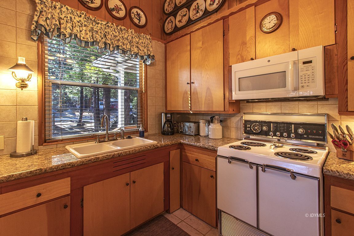 26710 Mc Mahon Road Idyllwild, CA 92549 - Photo 12 of 35 a kitchen with stainless steel appliances granite countertop a sink and a stove