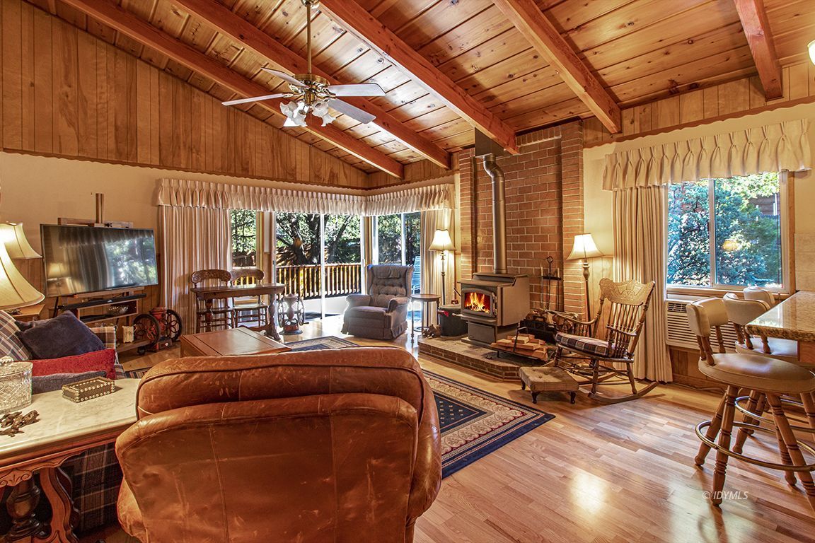 26710 Mc Mahon Road Idyllwild, CA 92549 - Photo 5 of 35 a living room with furniture a flat screen tv and floor to ceiling window
