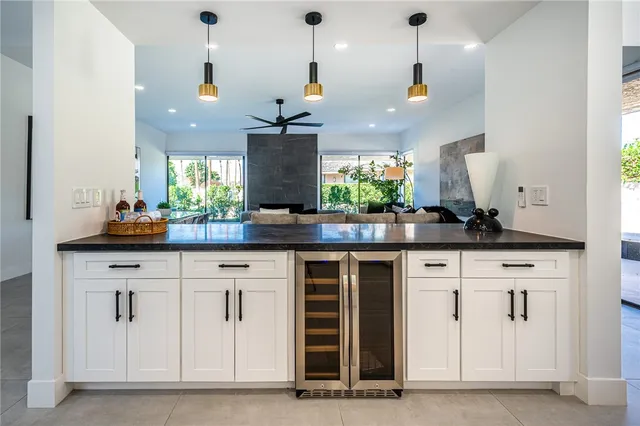 a kitchen with a sink and chandelier