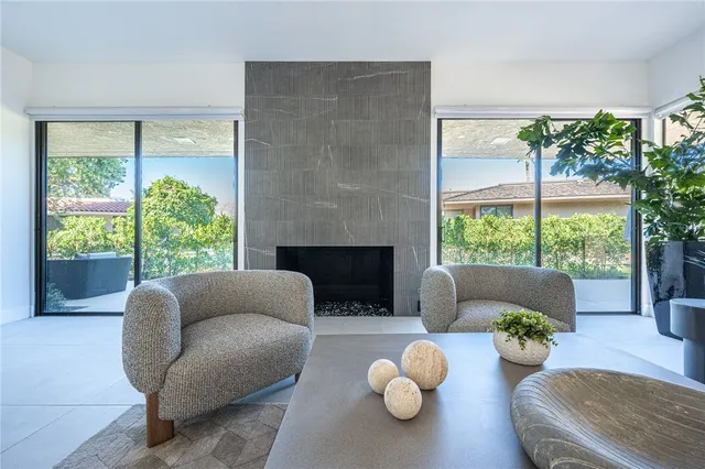 a living room with furniture and a floor to ceiling window