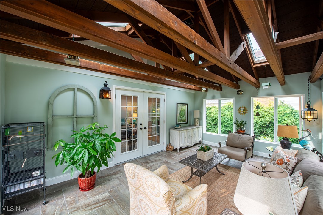28314 Knickerbocker Road Bay Village, OH 44140 - Photo 15 of 38 Tiled living room with french doors and lofted ceiling with beams