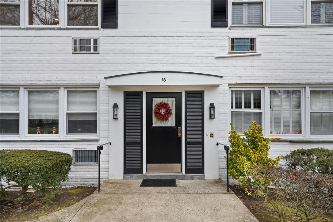 16 North Ridge Street, Unit C Rye Brook, NY 10573 - Photo 1 of 1 front view of a brick house with a window and potted plants