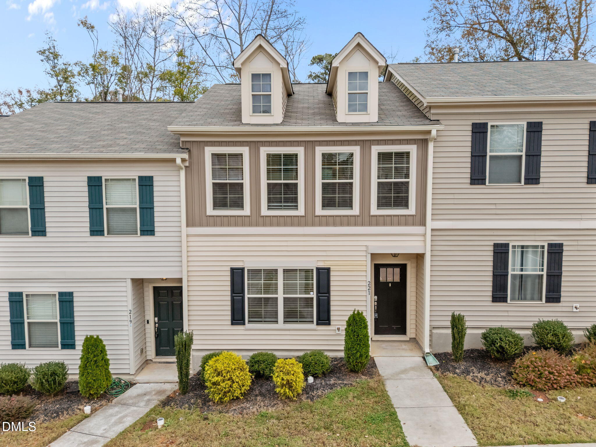 a front view of a house with outdoor seating