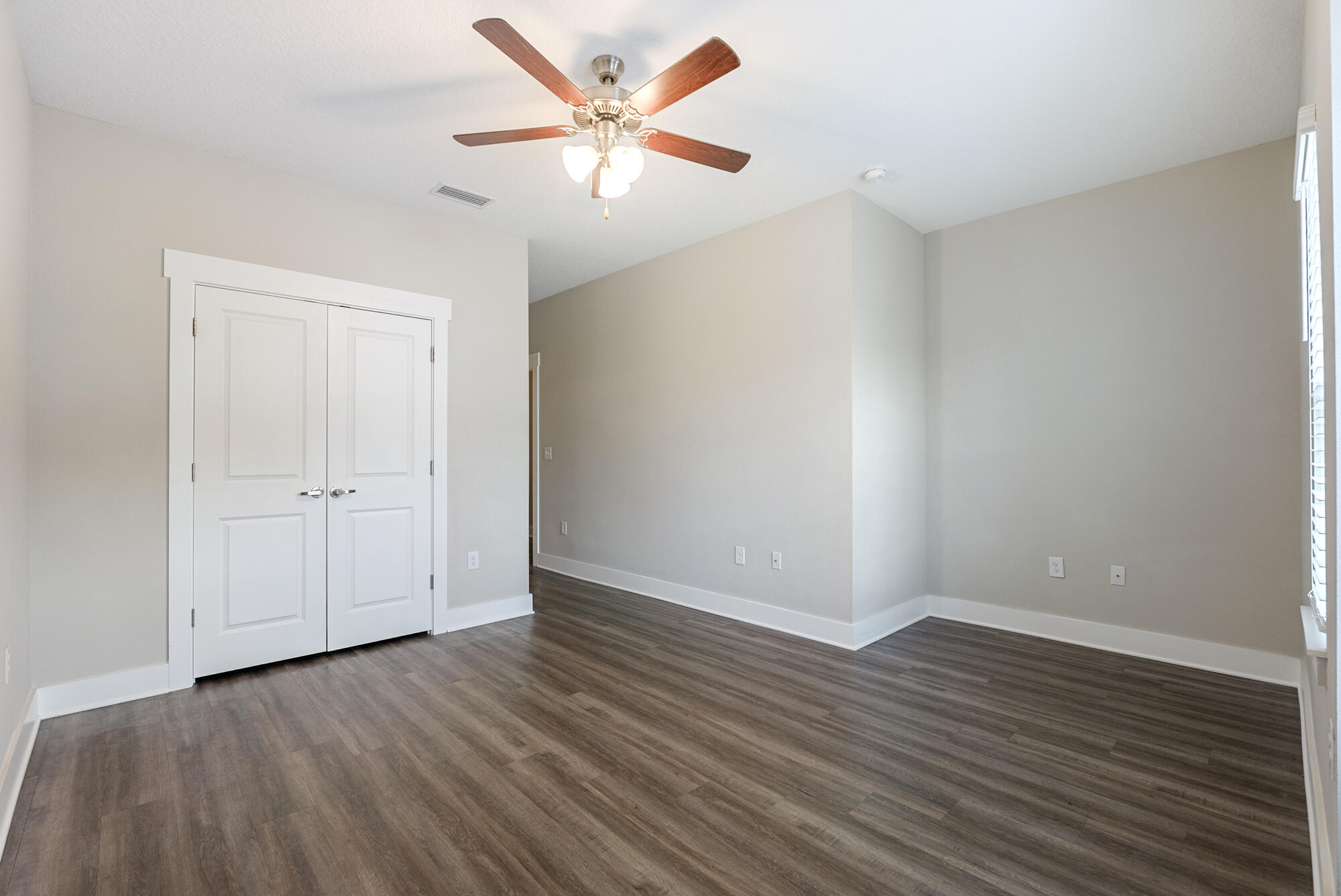 294 Date Palm Lane Freeport, FL 32439 - Photo 10 of 28 a view of an empty room with wooden floor