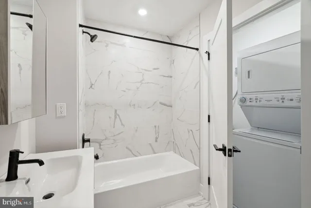 a bathroom with a tub and a shower