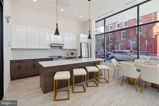 a large kitchen with a table and chairs