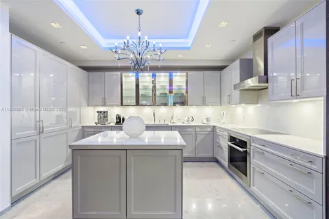 a kitchen with kitchen island granite countertop a sink stainless steel appliances and cabinets