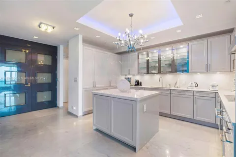 a kitchen with a sink and chandelier