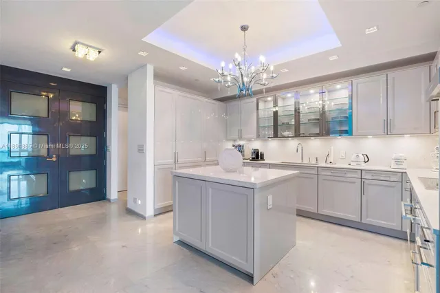 a kitchen with a sink and chandelier