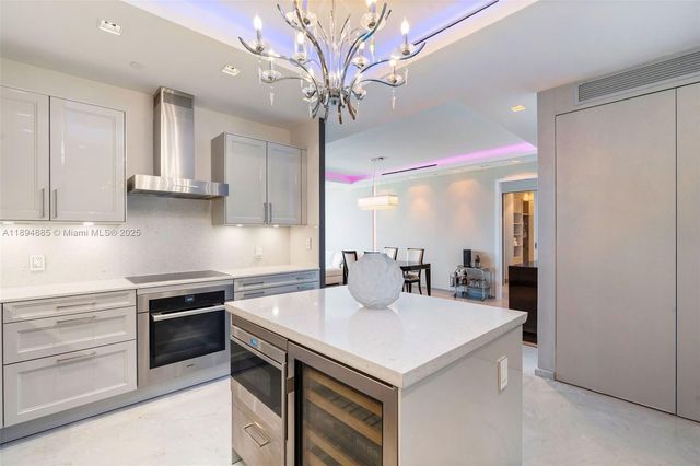 a kitchen with a sink a stove and cabinets