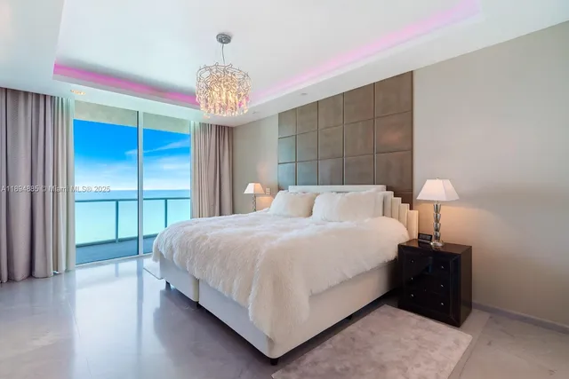 a bedroom with a bed and a chandelier