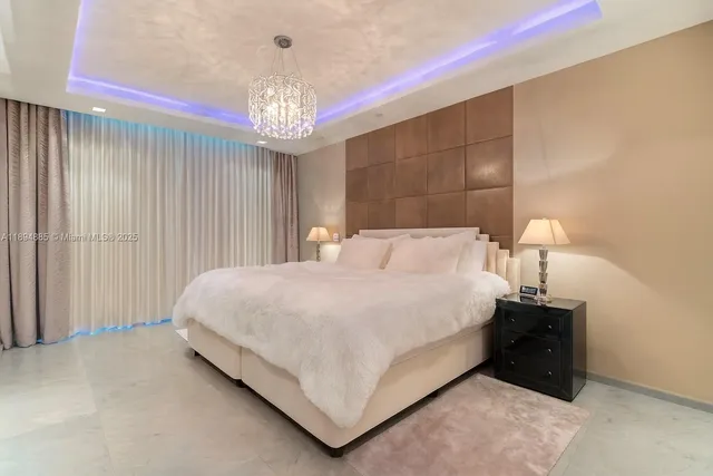 a bed room with a bed and a chandelier