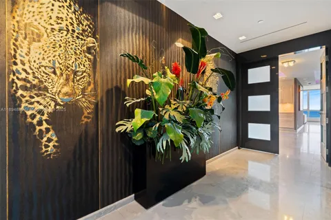 an aerial view of residential houses with outdoor space and ocean view