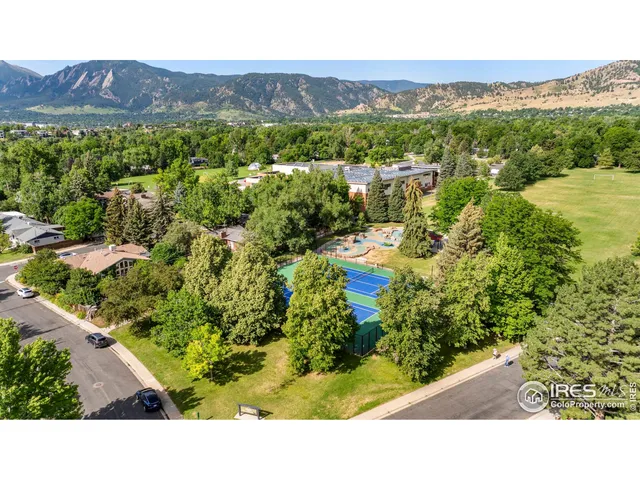 a view of a green field with mountains in the background