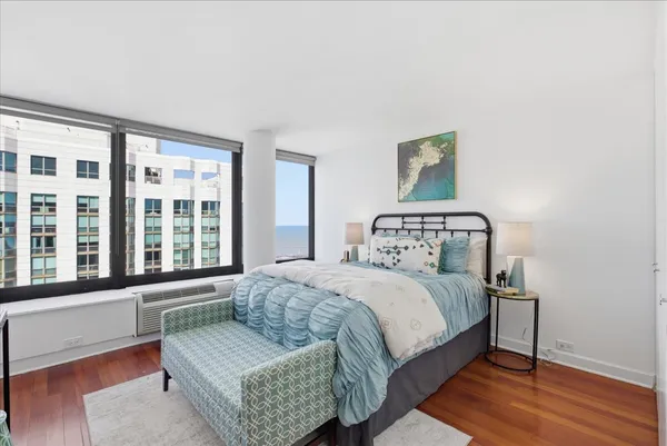 a bedroom with a bed and balcony view