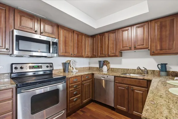 a kitchen with stainless steel appliances granite countertop a refrigerator and a sink
