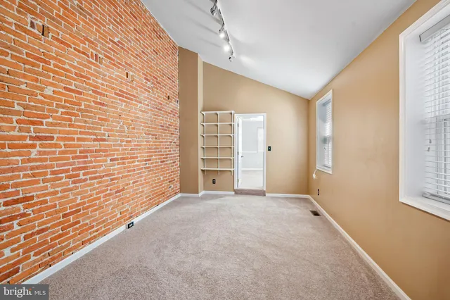 an empty room with a empty space and windows