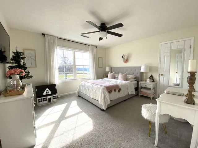 a spacious bedroom with a bed and a couch