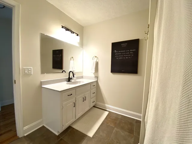 a view of a hallway with paintings on the wall