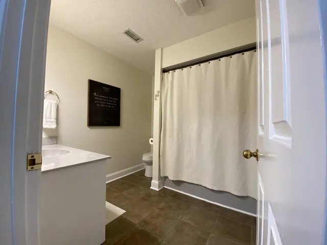 a bedroom with furniture and a flat screen tv