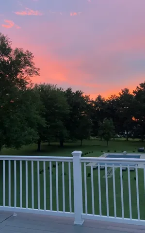 a kitchen with stainless steel appliances granite countertop a stove top oven a sink dishwasher a dining table and chairs with wooden floor