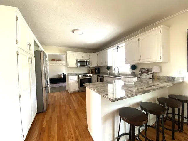 a large bed sitting in a bedroom next to a window