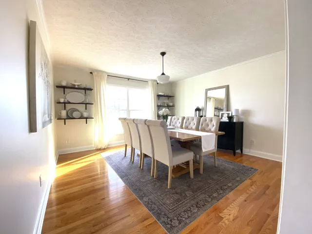 a dining room with furniture and wooden floor