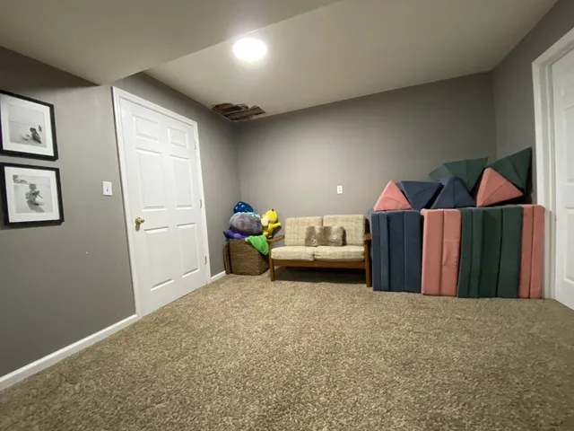 a room with water heater and wooden shelves