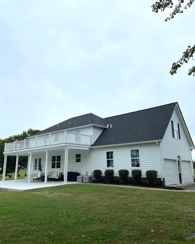 a view of a balcony with a yard